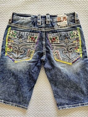Rock Revival Blue Denim Shorts with Colorful Embroidered Pockets.
